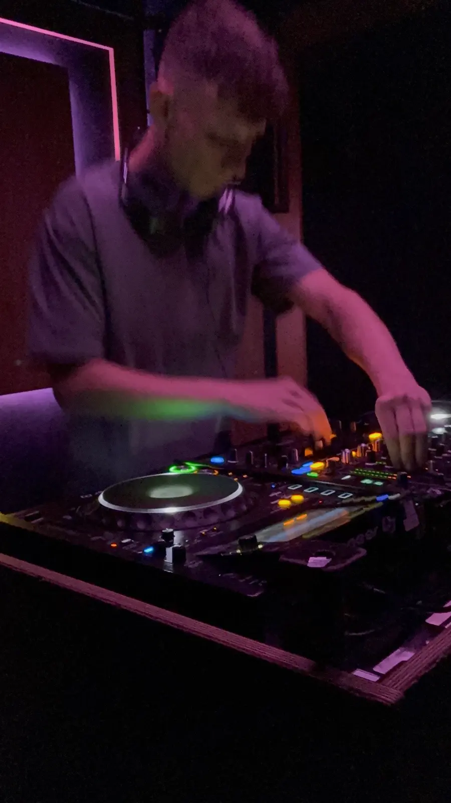 Behind the CDJs under purple wash
